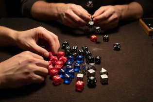 Rolling numbered dice across a green parlour felt cloth